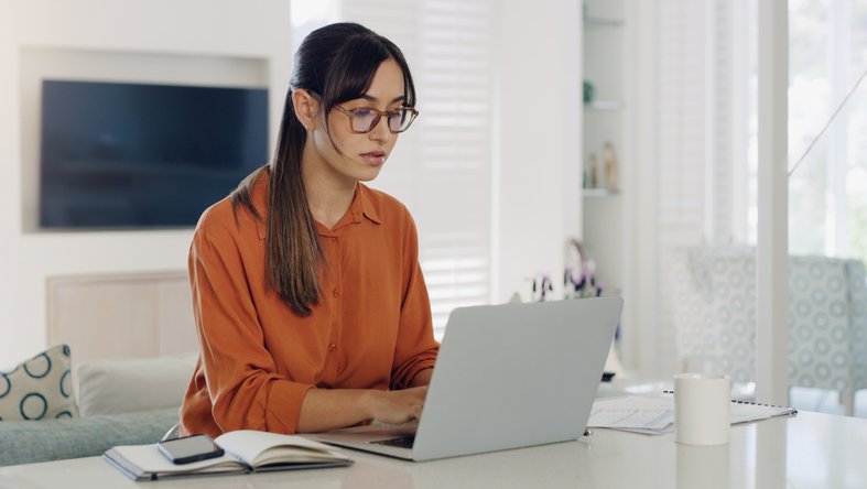 A woman researching the advantages and drawbacks of opening a conduit IRA.