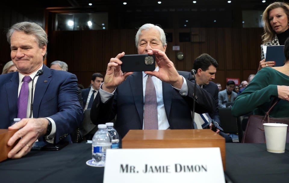 WASHINGTON, DC - DECEMBER 06: Jamie Dimon, Chairman and CEO of JPMorgan Chase, takes a picture of news photographers as he arrives to testify at a Senate Banking Committee hearing at the Hart Senate Office Building on December 06, 2023 in Washington, DC. The committee heard testimony from the largest financial institutions during an oversight hearing on Wall Street firms. (Photo by Win McNamee/Getty Images)