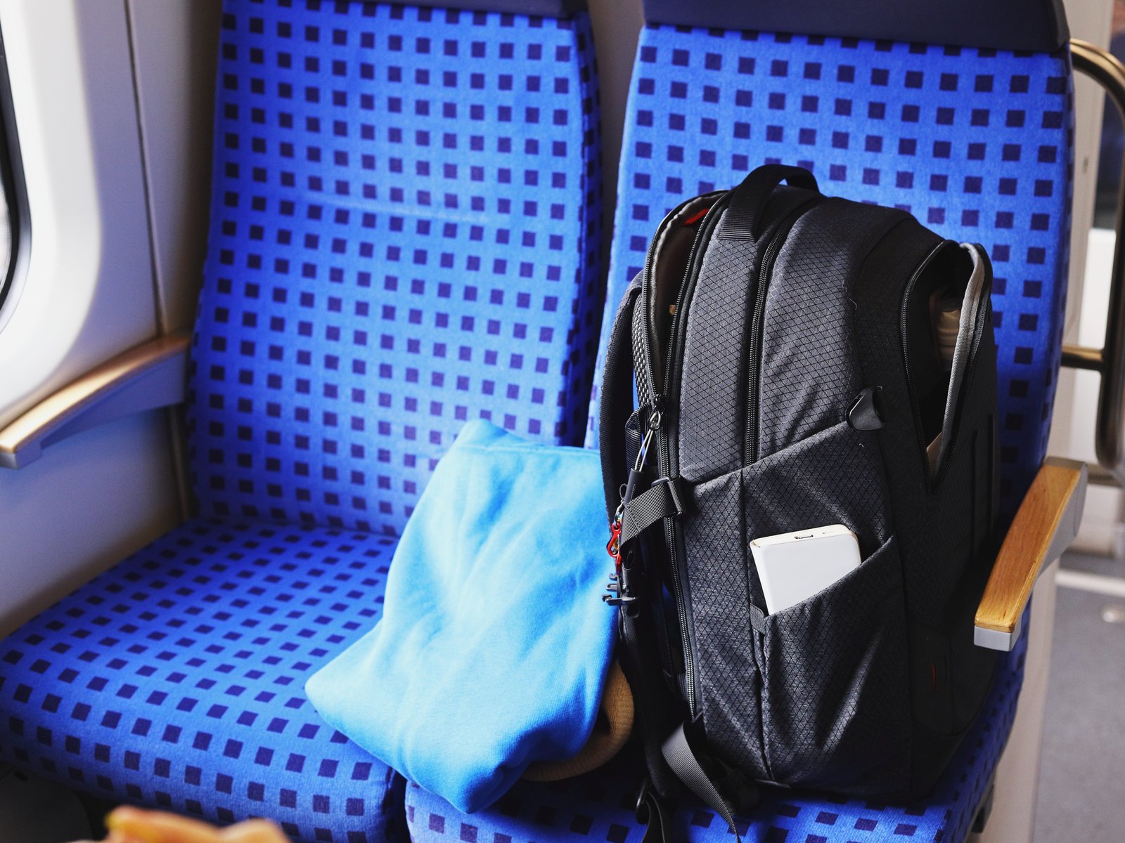 A backpack left on a seat on a train.