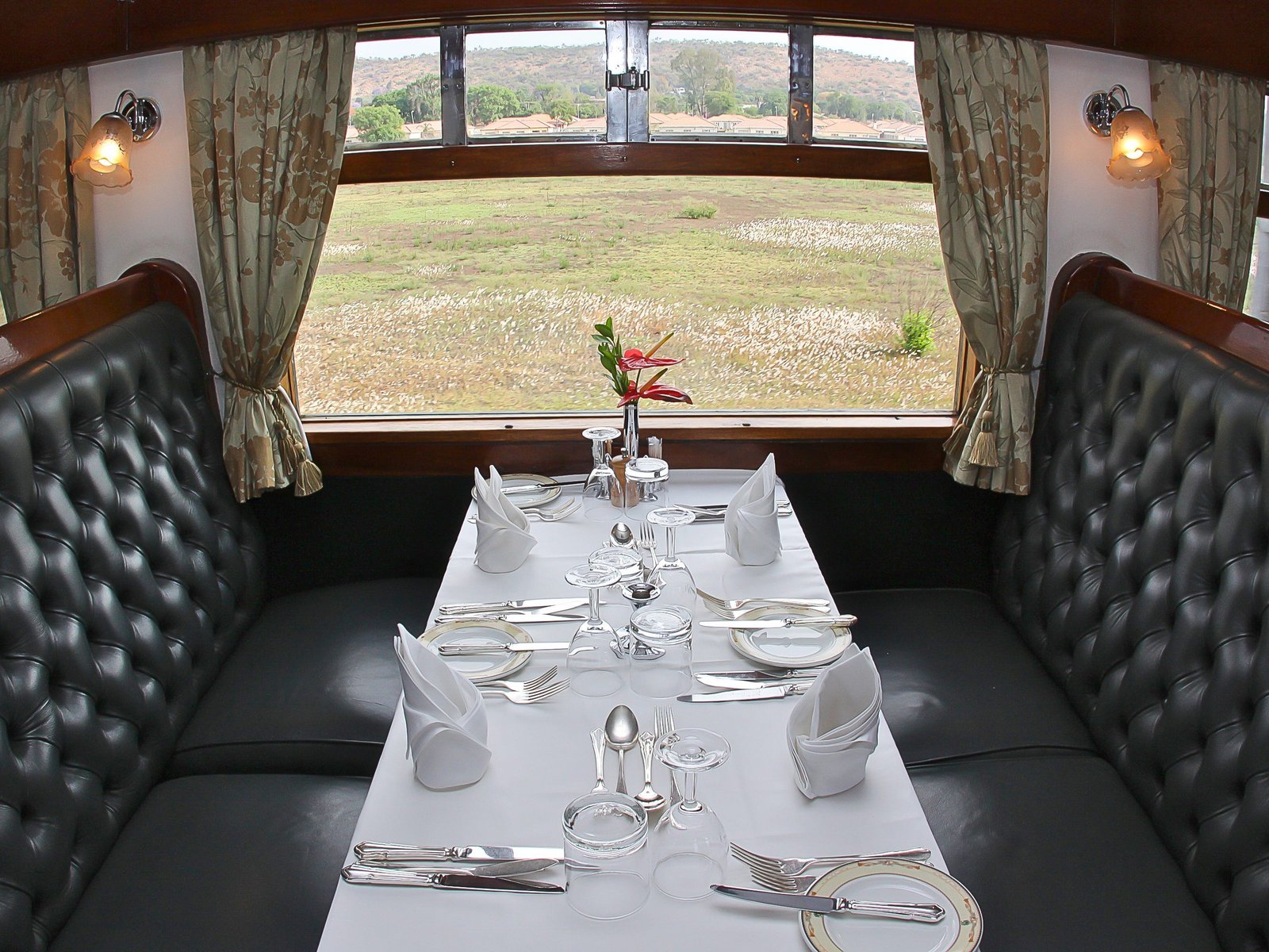 A set table in a train dining cart.