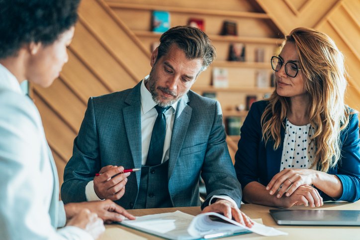 Clients reviewing a cross-border tax plan with a financial advisor.