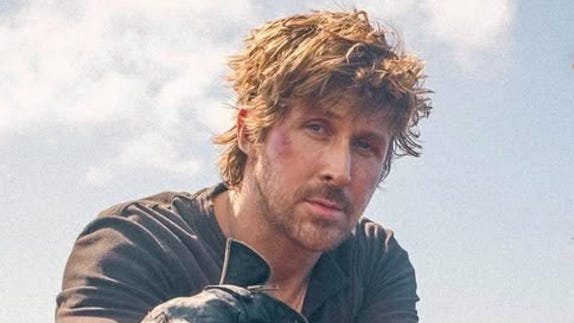 Ryan Gosling leaning on a handle