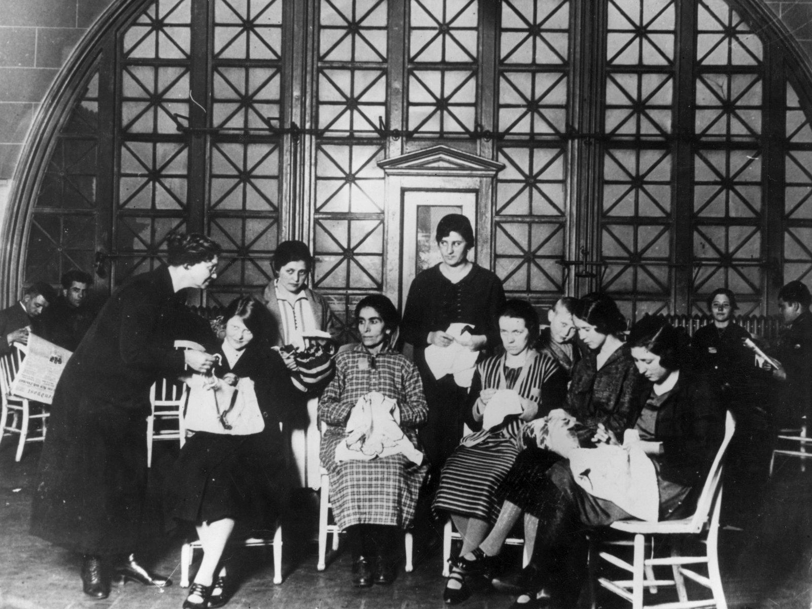 A group of immigrant women doing embroidery on Ellis Island in 1920.