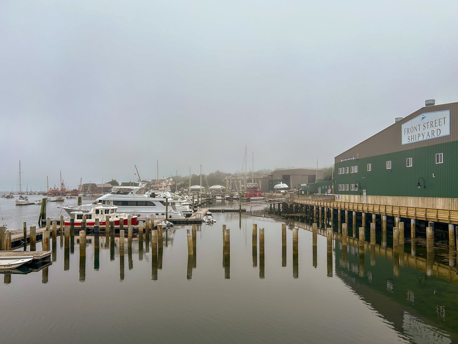 A bay full of boats at Front Street Shipyard on a cloudy, foggy day in Belfast, Maine
