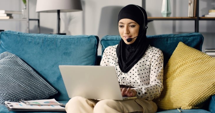 Woman working from home using headset.