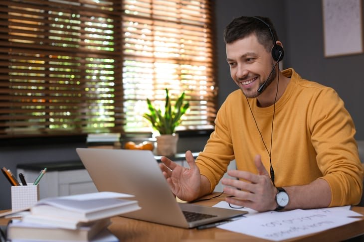 Man working from home using headset.