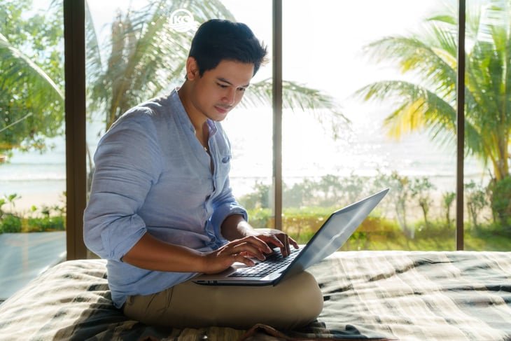 Man working on a laptop during his vacation