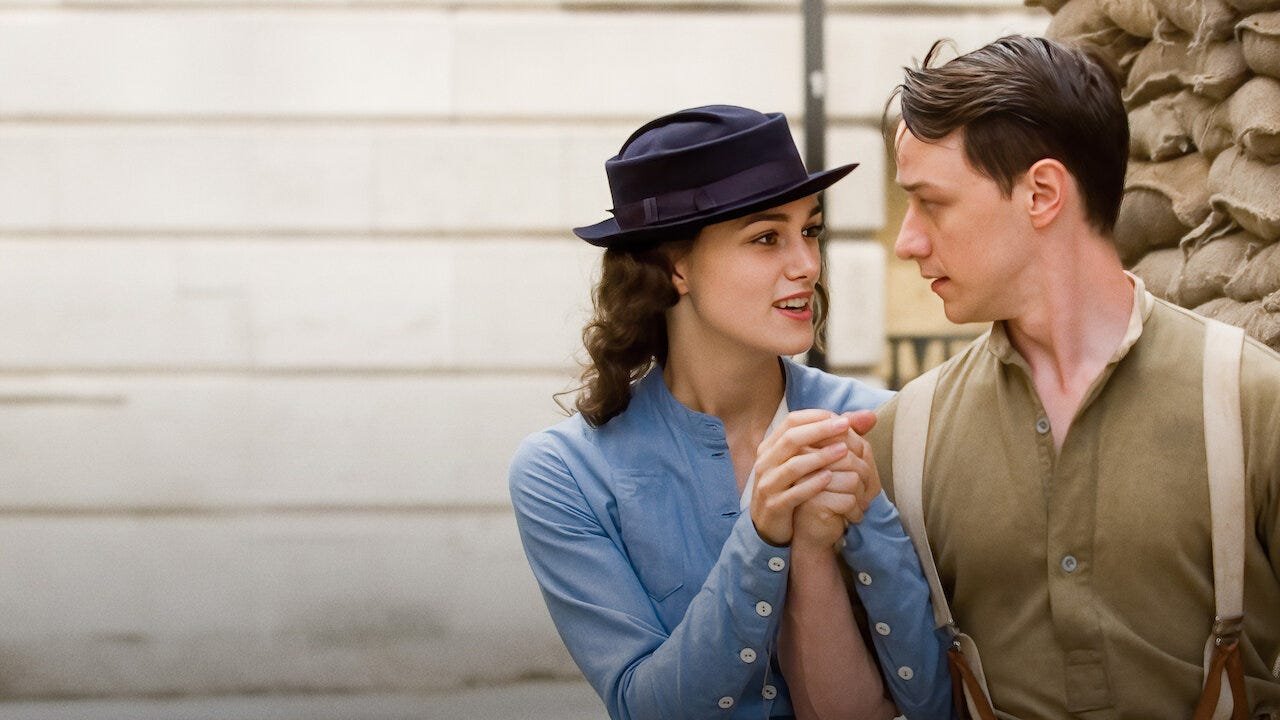 Keira Knightley holding onto James McAvoy's hand in Atonement
