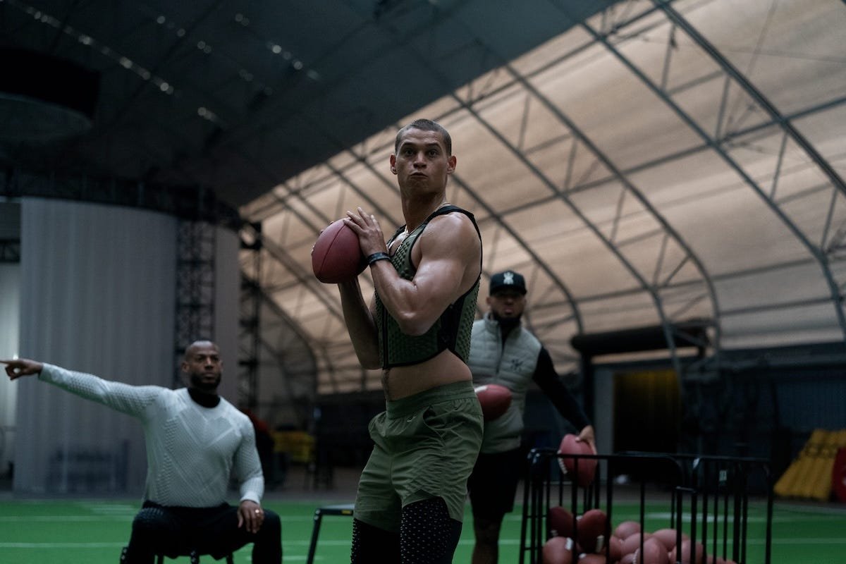 Tyriq Withers throwing a football and Marlon Wayans pointing in Him