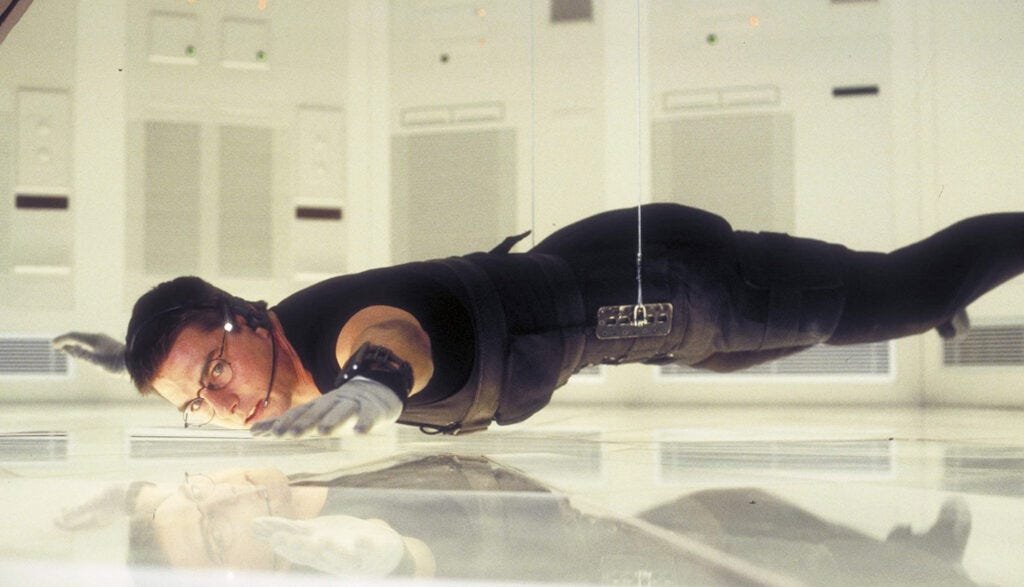Tom Cruise hanging off the floor in Mission Impossible