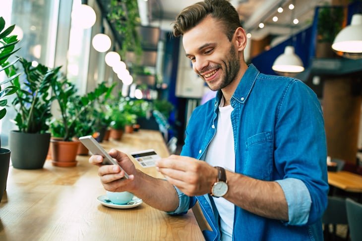 Man shopping with credit card on his phone
