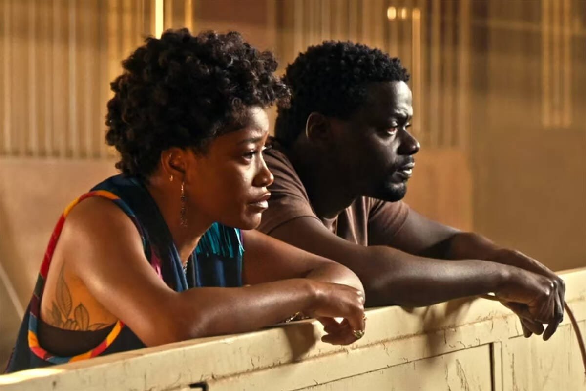 Keke Palmer and Daniel Kaluuya leaning on a fence post in Nope movie
