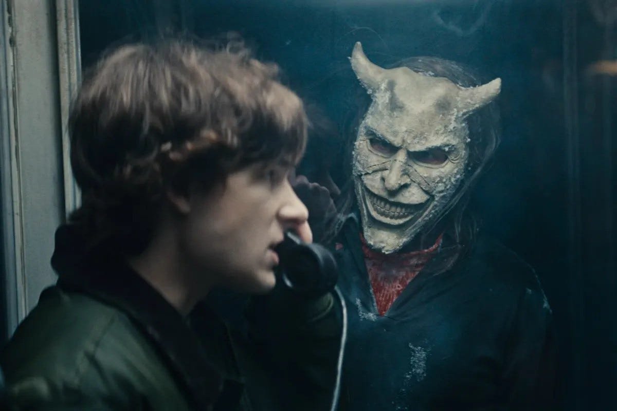 The Grabber looking at a boy on the phone in Black Phone 2