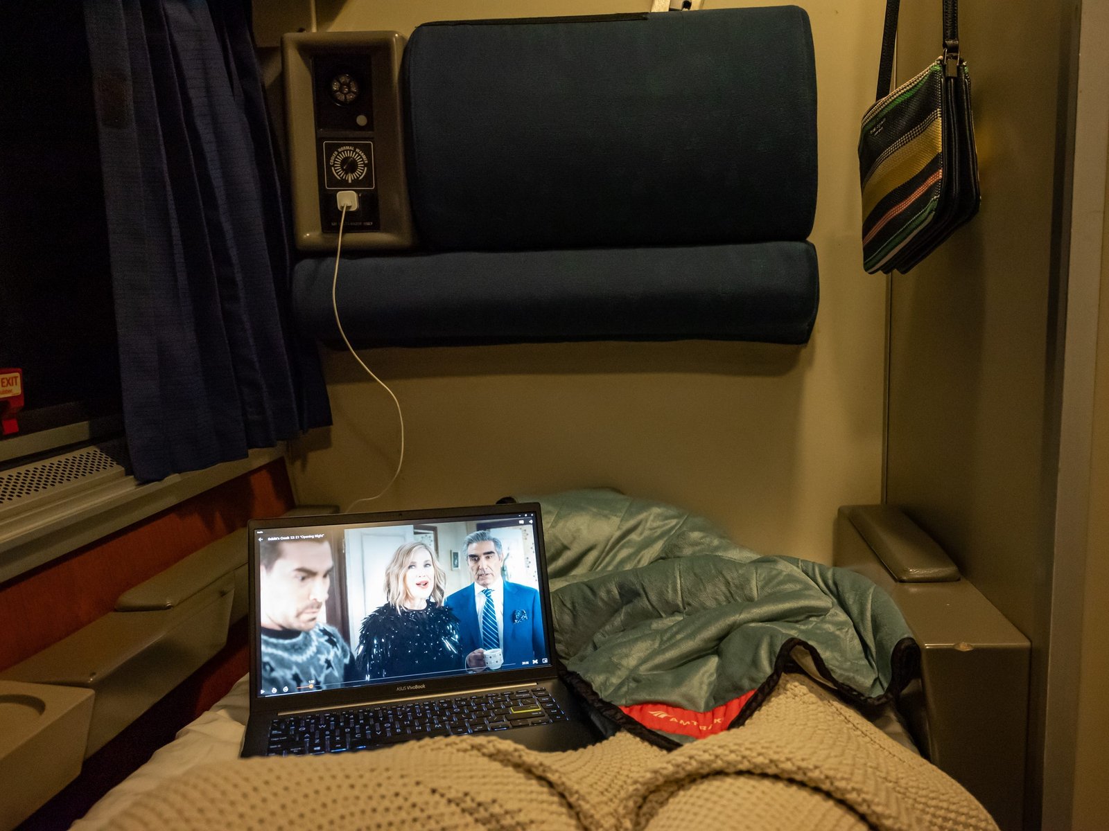 POV of the writer in bed watching TV on her laptop