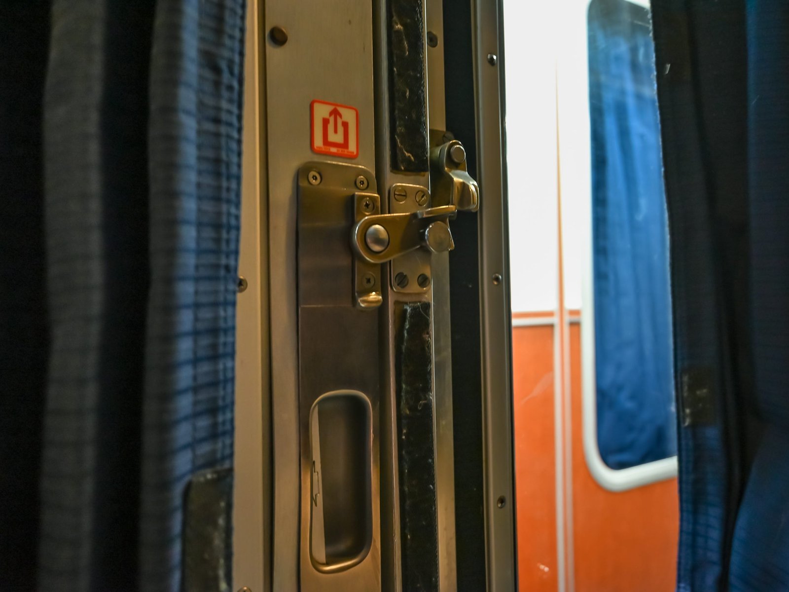 Latch on a metal door to an Amtrak sleeper car