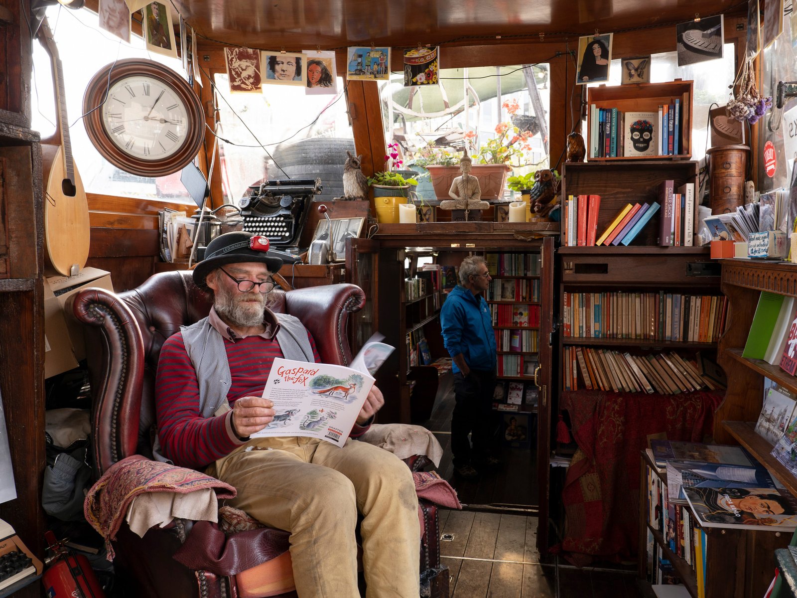 A man reading in a chair at Word on the Water in London.