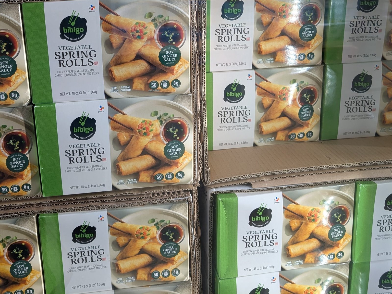 Multiple boxes of Bibigo vegetable spring rolls.