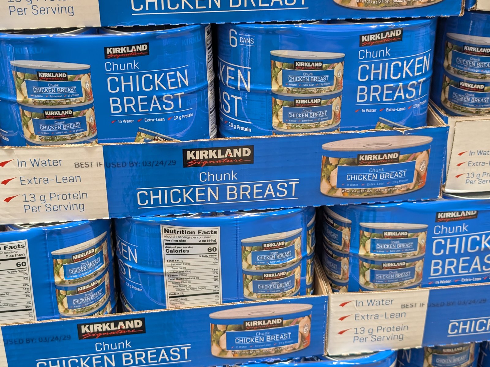 Multiple containers of Kirkland Signature chicken breast chunks.