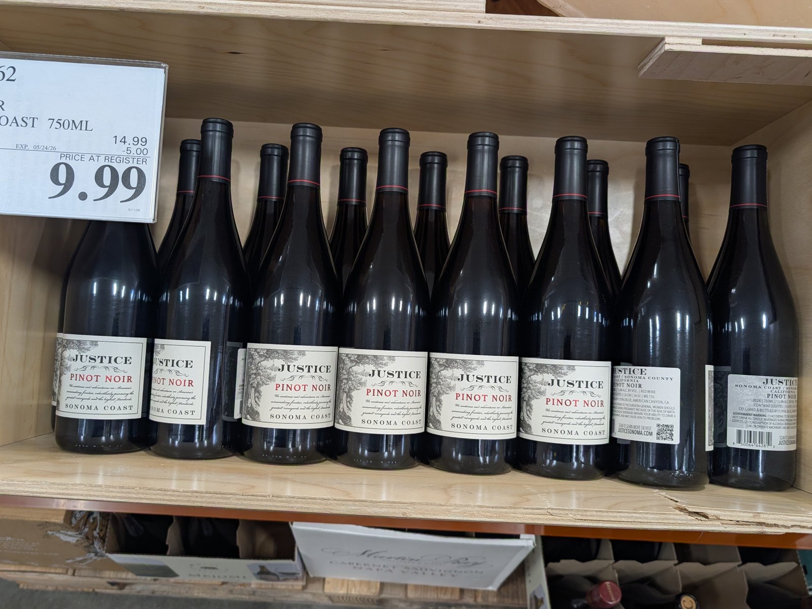 Multiple bottles of Justice pinot noir on a shelf at Costco.