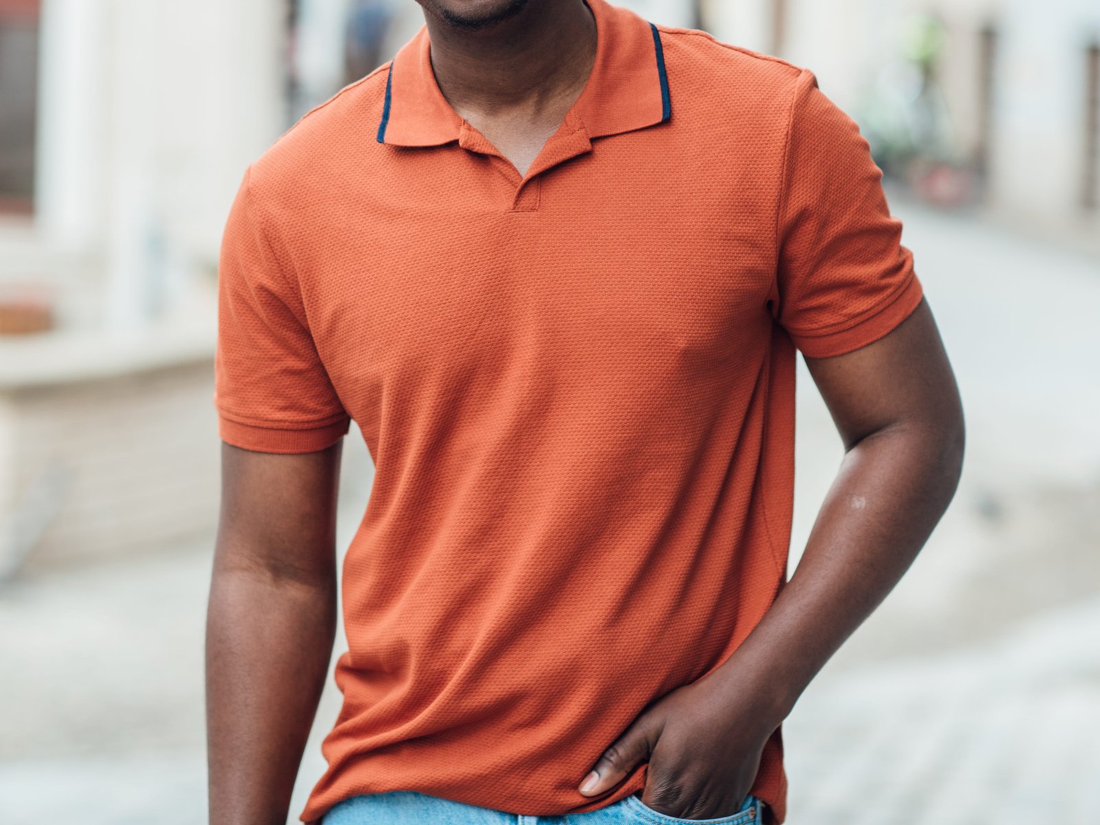 A man wearing an orange polo shirt.