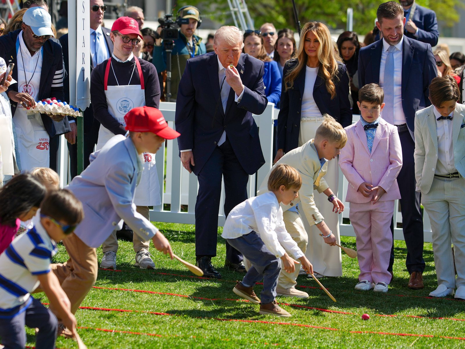 President Trump blowing a whistle as kids compete in the Easter egg roll