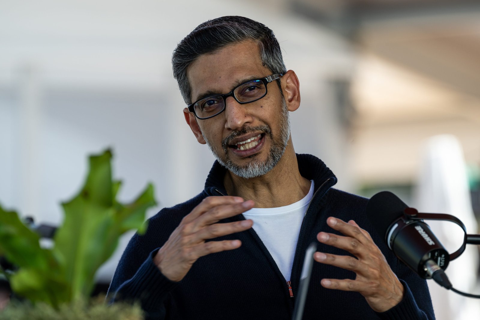 Google CEO Sundar Pichai is raising his hands.