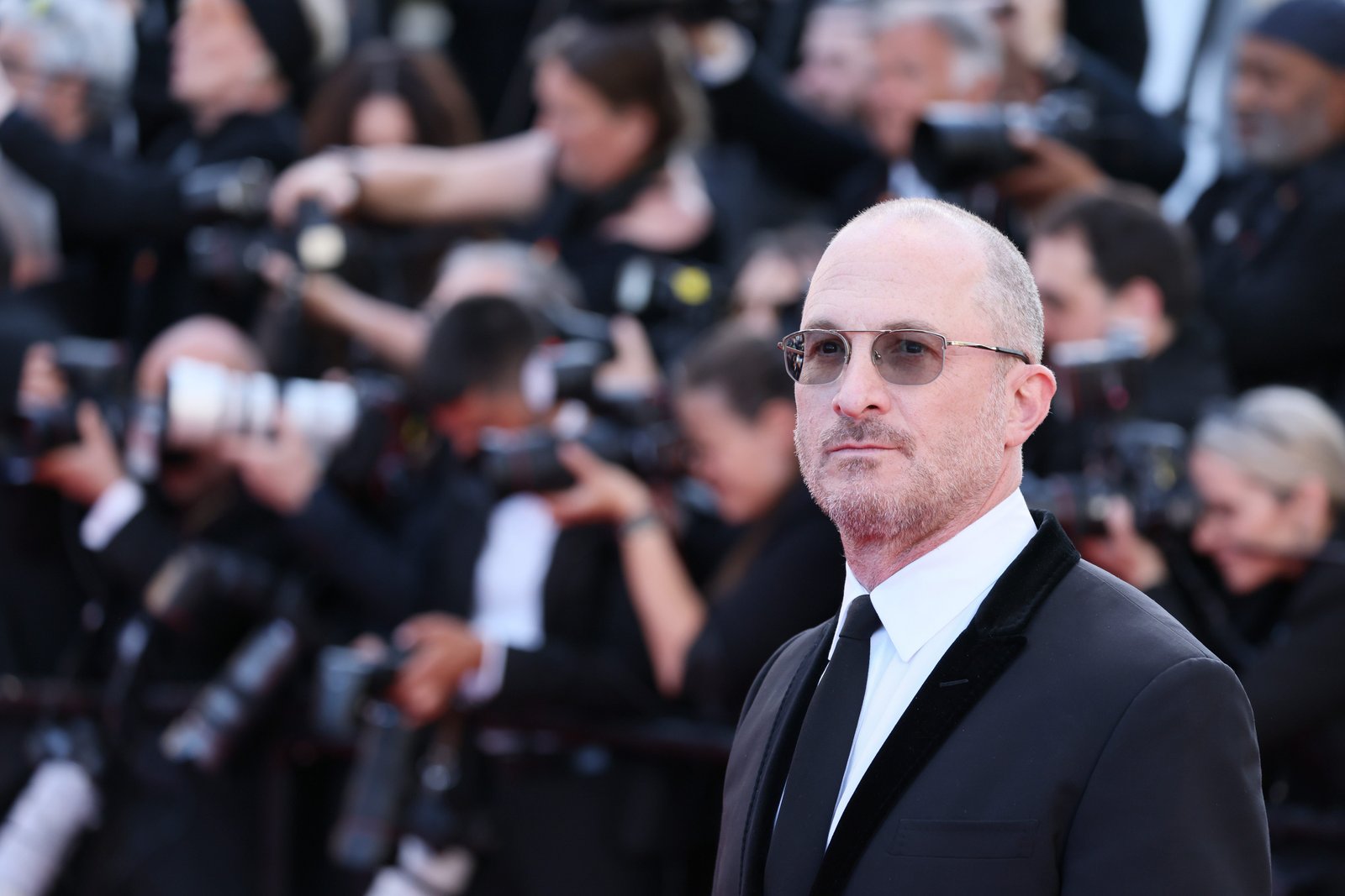 Darren Aronofsky in a black suit and tie
