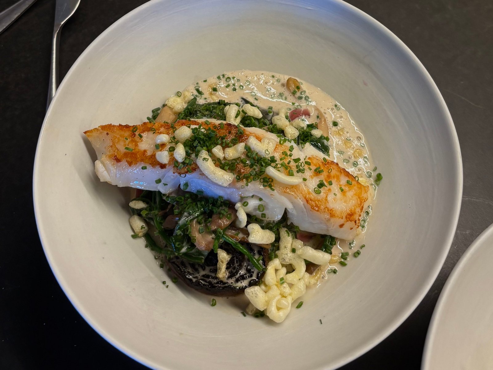 A dish with fish and pasta.