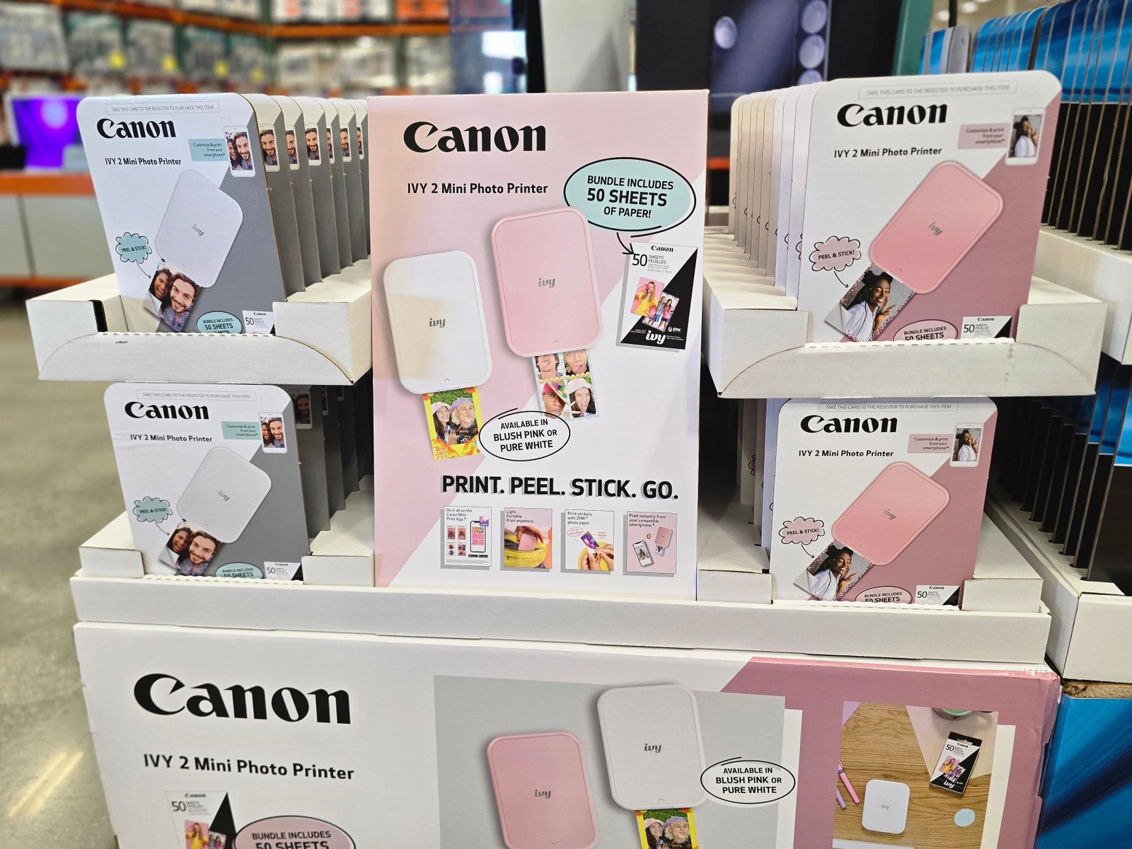 Boxes of Canon Ivy 2 mini photo printers on display at Costco.