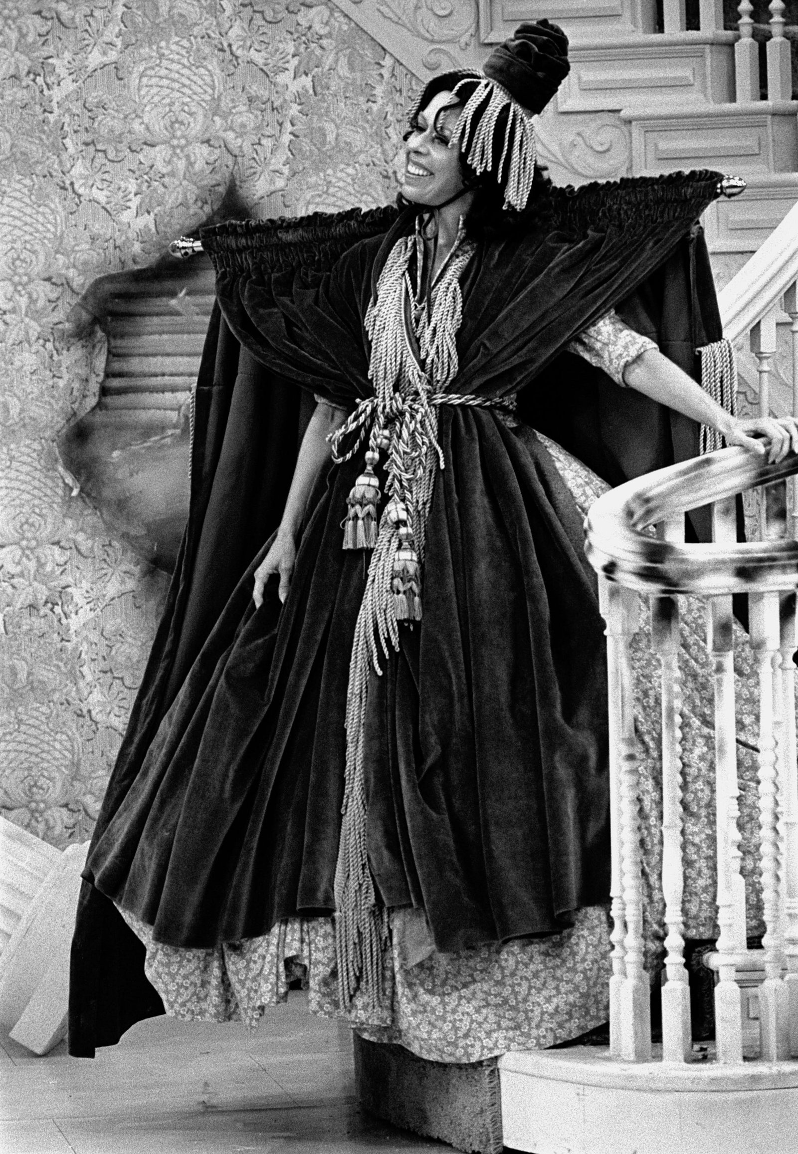 In a scene from 'The Carol Burnett Show,' American comedienne and actress Carol Burnett descends a staircase, dressed in dress made from a window curtain (compete with the curtain rod) during a parody of 'Gone With The Wind,' August 20, 1976.
