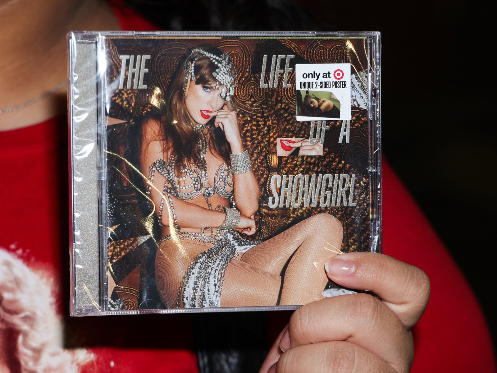 Fans pose with Taylor Swift's new album 'The Life of a Showgirl' during the midnight release at Target on October 03, 2025 in Burbank, California.